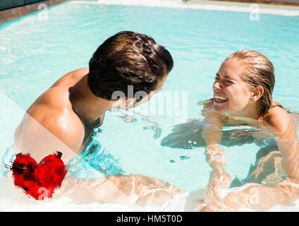 Couple having fun in swimming pool Stock Photo