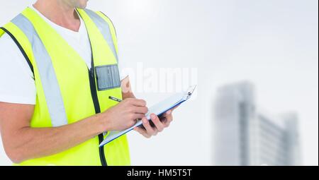 Construction man writing on clipboard against white background Stock Photo