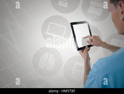 Doctor using digital tablet against digitally generated icons Stock Photo