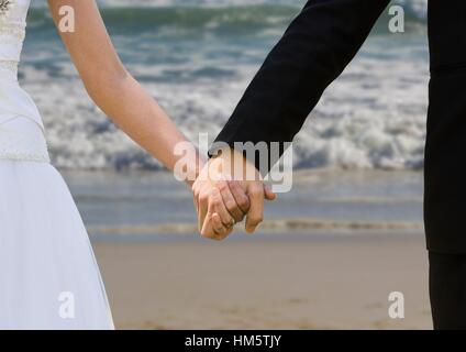 Newly wed couple holding hands Stock Photo