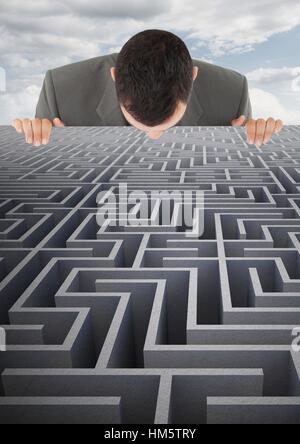 Conceptual image of businessman looking over maze Stock Photo
