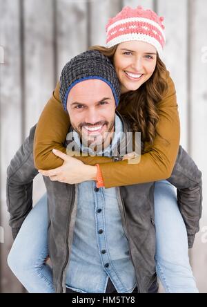 Man giving piggy back to woman Stock Photo