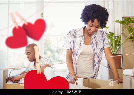 Couple unpacking cardboard boxes Stock Photo