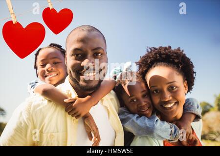 Happy parents giving piggyback to their children Stock Photo