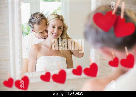 Romantic couple embracing in front of mirror Stock Photo