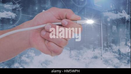Hand holding computer cable and flare against digitally generated background Stock Photo