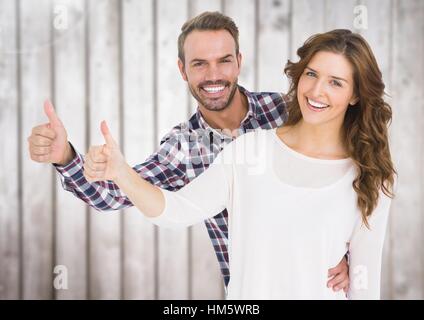 Happy couple giving thumbs up Stock Photo