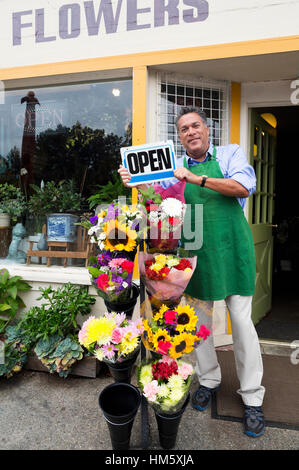 Portrait of male florist holding open sign Stock Photo