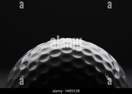 Close-up view of golf ball on black background Stock Photo