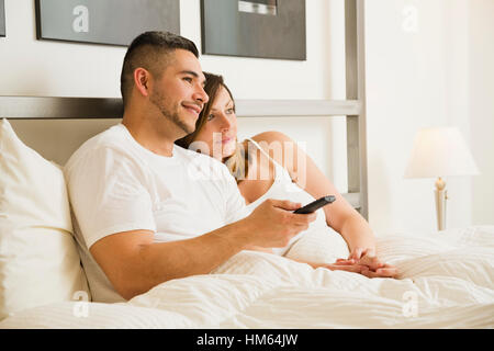 Young couple watching tv in morning Stock Photo