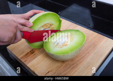 Slice  cantaloupe into a half Stock Photo