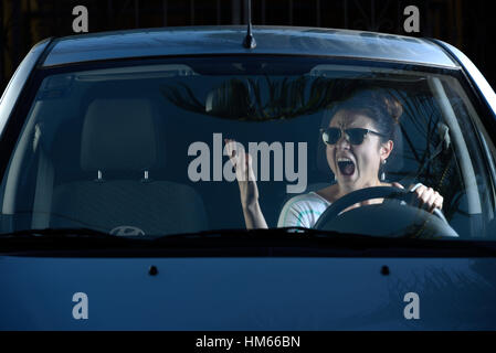 angry woman shouting at someone while driving Stock Photo