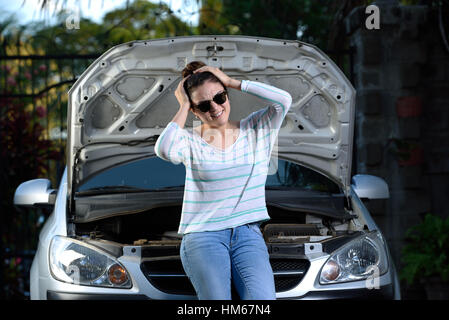 worried girl with her broken car and waiting Stock Photo