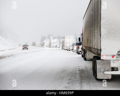 Snowy winter scene of cars and trucks on Trans-Canada Highway near Golden; British Columbia; Canada Stock Photo