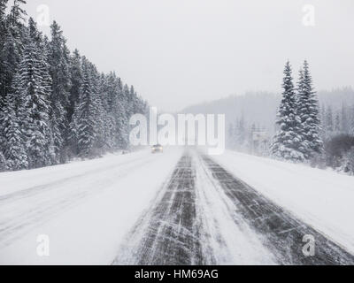 Snowy winter scene of cars and trucks on Trans-Canada Highway near Golden; British Columbia; Canada Stock Photo