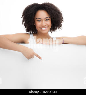 Young Smileing teenager african girl hold black blank paper and shows on it. Stock Photo