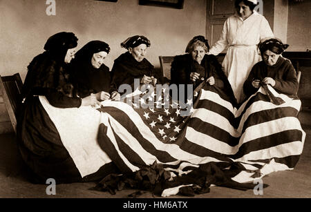 Patriotic old women make flags.  Born in Hungary, Galicia, Russia, Germany, Rumania.  Their flag-making instructor, Rose Radin, is standing.  Ca. 1918.   Underwood & Underwood. (War Dept.) Exact Date Shot Unknown NARA FILE #:  165-WW-199A-3 WAR & CONFLICT BOOK #:  504 Stock Photo