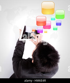 Business man using a touch screen device with colorful application icons Stock Photo