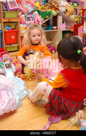 Children playing with Barbie dolls Stock Photo