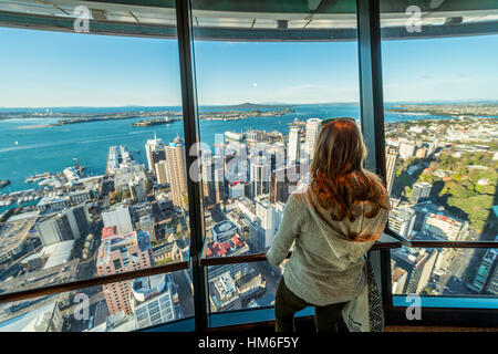 Tourist enjoying the view from the observation deck of the Sky Tower, skyline with skyscrapers, Central Business District Stock Photo