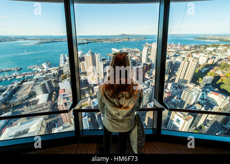 Tourist enjoying the view from the observation deck of the Sky Tower, skyline with skyscrapers, Central Business District Stock Photo