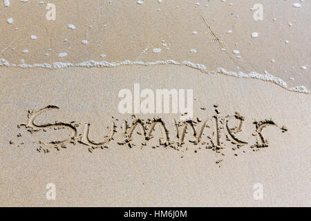 Summer handwritten inscription in sand on a beach Stock Photo