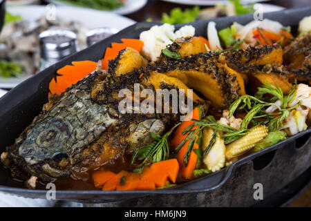 Sour curry with deep-fried snake headed fish Stock Photo