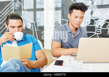 Two programmers with computer in start-up office Stock Photo