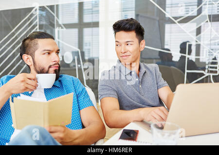 Two programmers in as start-up team working as a team Stock Photo