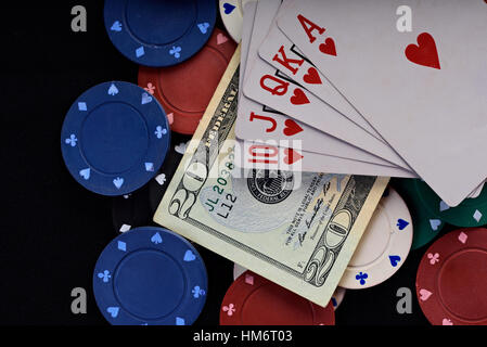 gamble set chips cards and money on black table Stock Photo