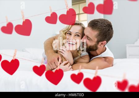 Happy couple embracing on sofa Stock Photo
