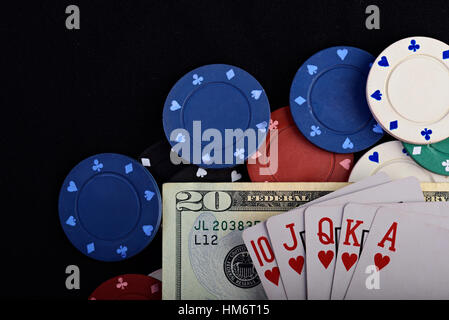 gambling chips and cards with dollar on black table Stock Photo