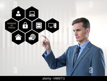 Businessman touching digitally generated connecting icons Stock Photo