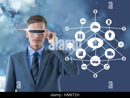 Business man wearing vr glasses standing next to digitally generated connecting icons Stock Photo