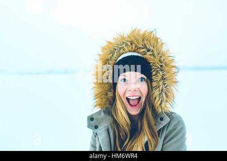 Portrait of woman with mouth open wearing fur hood during winter Stock Photo