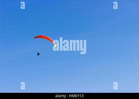 A powered parachute flies above Playa Hermosa at Uvita, Costa Rica. Stock Photo