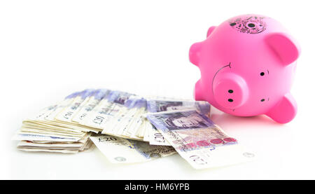 Pink Piggy Bank with a pile of banknotes on a white background Stock Photo