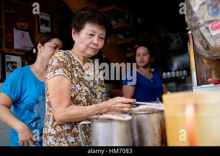 Phan Dinh Phung street, Ho Chi Minh city, Viet Nam - FEB 7: Unidentified woman with private business at home by cafe store. Coffee is favorite drink a Stock Photo