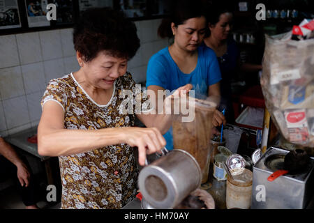 Phan Dinh Phung street, Ho Chi Minh city, Viet Nam - FEB 7: Unidentified woman with private business at home by cafe store. Coffee is favorite drink a Stock Photo