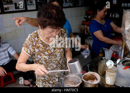 Phan Dinh Phung street, Ho Chi Minh city, Viet Nam - FEB 7: Unidentified woman with private business at home by cafe store. Coffee is favorite drink a Stock Photo