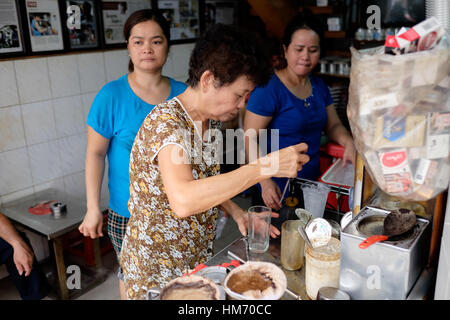 Phan Dinh Phung street, Ho Chi Minh city, Viet Nam - FEB 7: Unidentified woman with private business at home by cafe store. Coffee is favorite drink a Stock Photo