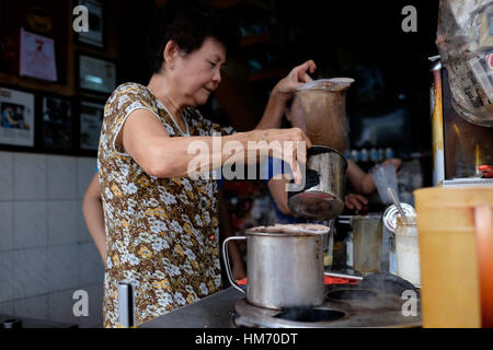 Phan Dinh Phung street, Ho Chi Minh city, Viet Nam - FEB 7: Unidentified woman with private business at home by cafe store. Coffee is favorite drink a Stock Photo