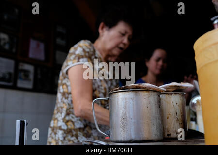 Phan Dinh Phung street, Ho Chi Minh city, Viet Nam - FEB 7: Unidentified woman with private business at home by cafe store. Coffee is favorite drink a Stock Photo