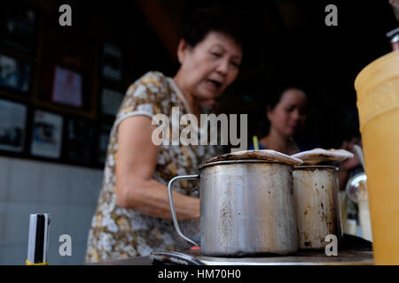 Phan Dinh Phung street, Ho Chi Minh city, Viet Nam - FEB 7: Unidentified woman with private business at home by cafe store. Coffee is favorite drink a Stock Photo