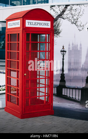 The London red public callbox stands on the sidewalk Stock Photo