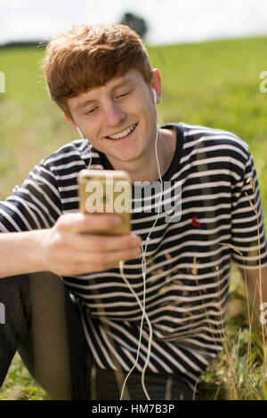 Boy having video chat on iphone Stock Photo