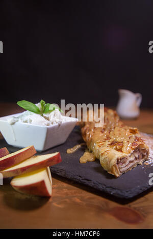 Apple pie with ice cream black background Stock Photo