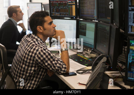 Young traders analyzing computer data Stock Photo
