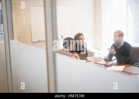 Young business people having meeting in board room