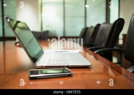 Empty conference table with mobile devices Stock Photo